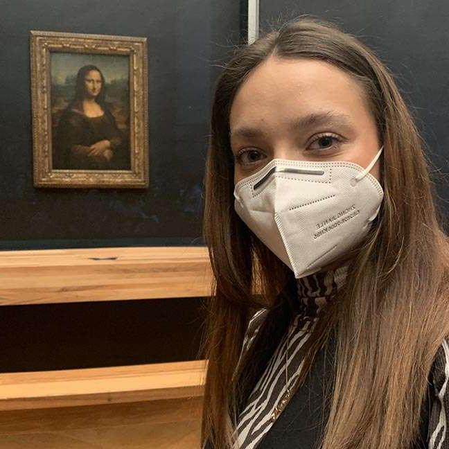 Sarah Pilut with the Mona Lisa during her study abroad experience